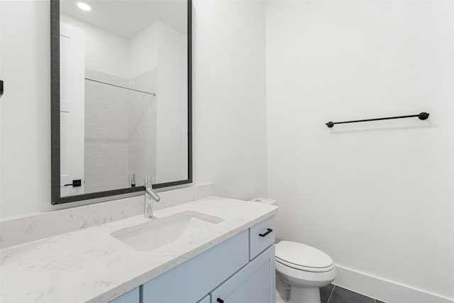 bathroom featuring tile patterned flooring, a shower, vanity, and toilet