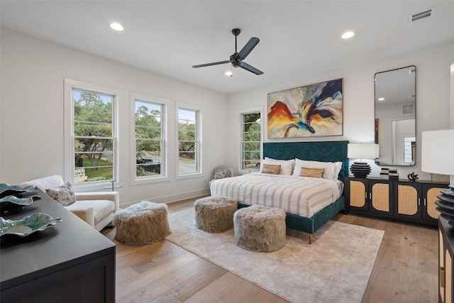 bedroom with light hardwood / wood-style flooring and ceiling fan