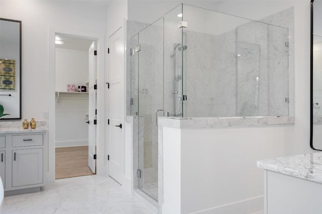 bathroom featuring vanity and a shower with shower door