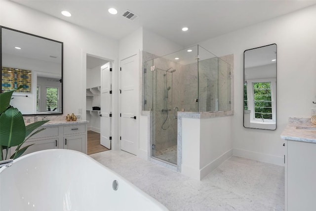 bathroom featuring vanity and separate shower and tub