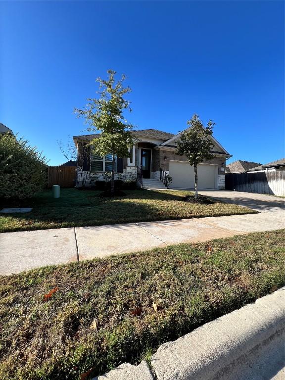 view of front of home with a front yard and a garage