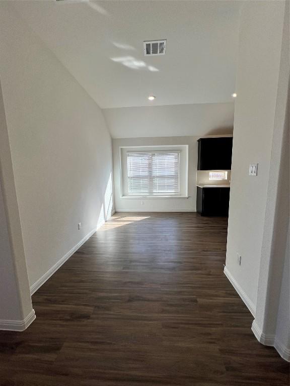 unfurnished living room with dark wood-type flooring