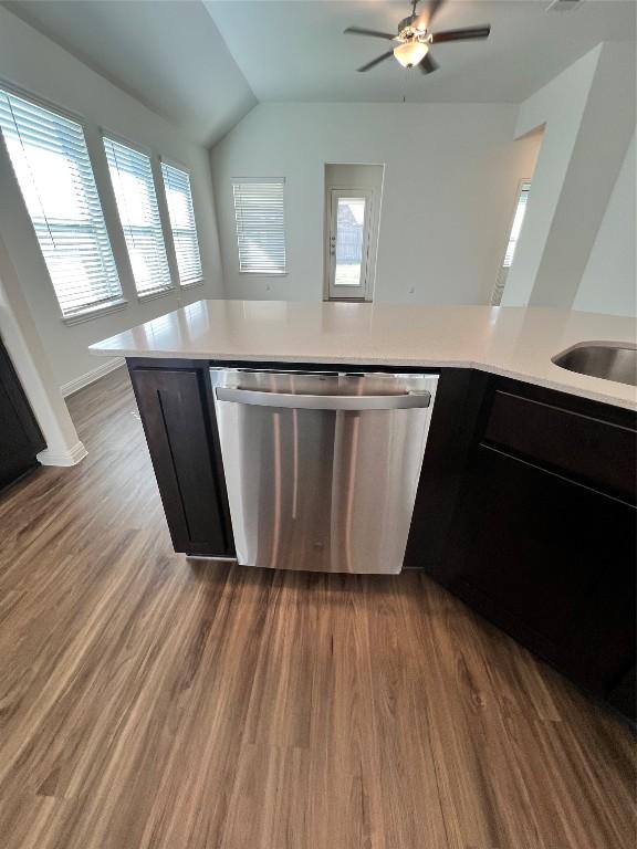 kitchen with stainless steel dishwasher, dark hardwood / wood-style floors, ceiling fan, and kitchen peninsula