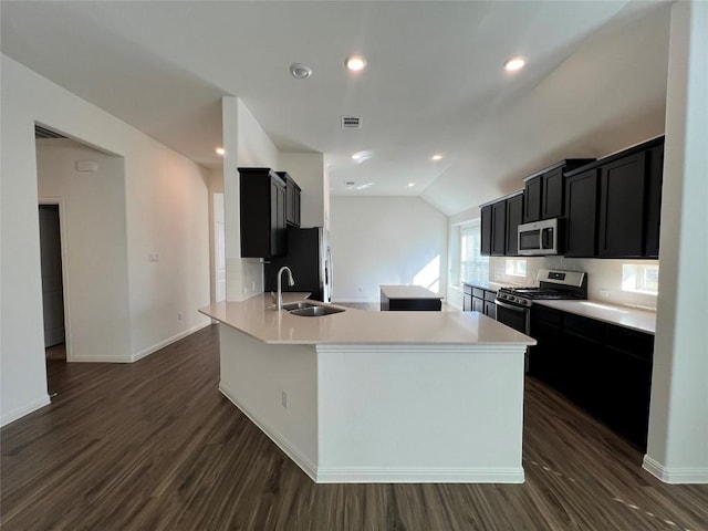 kitchen featuring sink, a center island, dark hardwood / wood-style floors, lofted ceiling, and appliances with stainless steel finishes