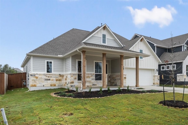 view of front of property with a front yard, a porch, and a garage