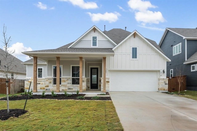 view of front of house featuring a porch, a garage, and a front lawn