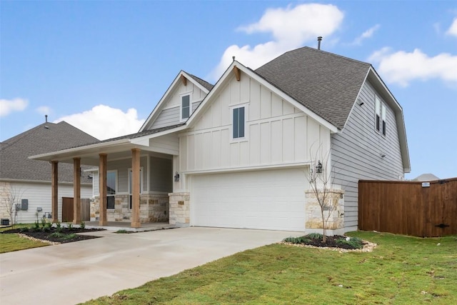 view of front of house with a porch, a garage, and a front yard