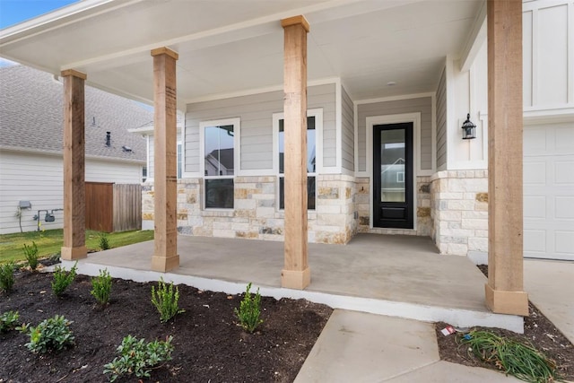 entrance to property with covered porch and a garage