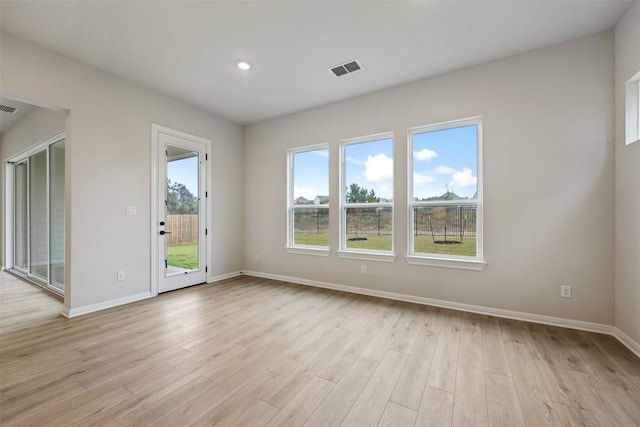 spare room featuring light hardwood / wood-style floors