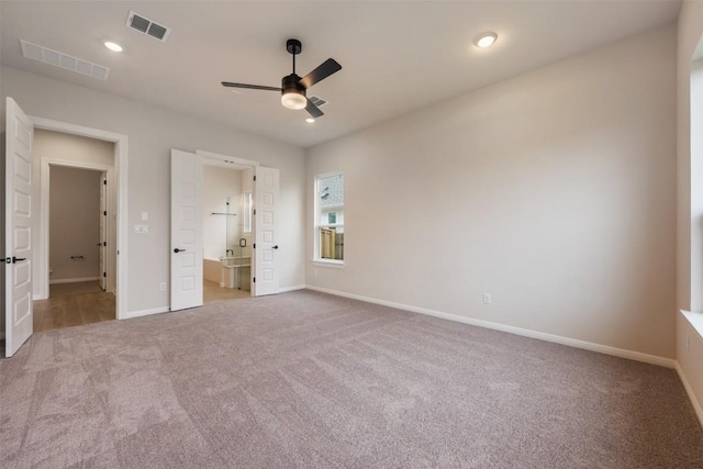 unfurnished bedroom featuring ensuite bathroom, ceiling fan, and light carpet