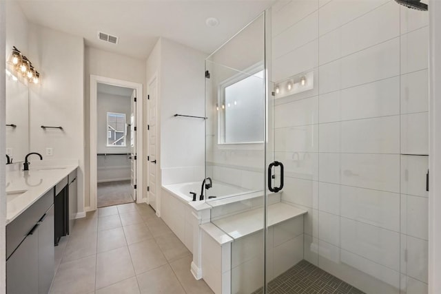 bathroom featuring tile patterned floors, vanity, and separate shower and tub