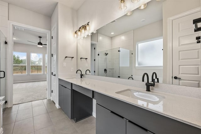 bathroom with ceiling fan, tile patterned flooring, vanity, and a shower with door