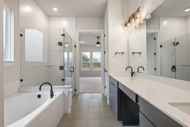 bathroom with vanity, ceiling fan, tile patterned flooring, and plus walk in shower