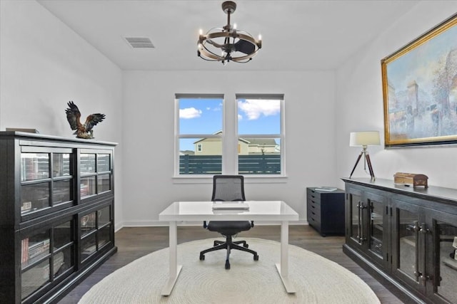 office with dark hardwood / wood-style floors and a chandelier