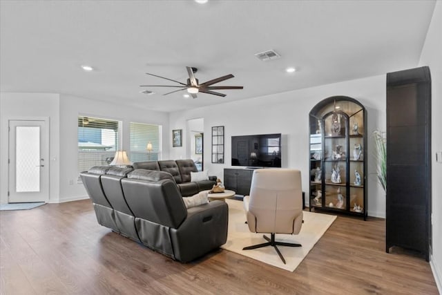 living room with hardwood / wood-style flooring and ceiling fan