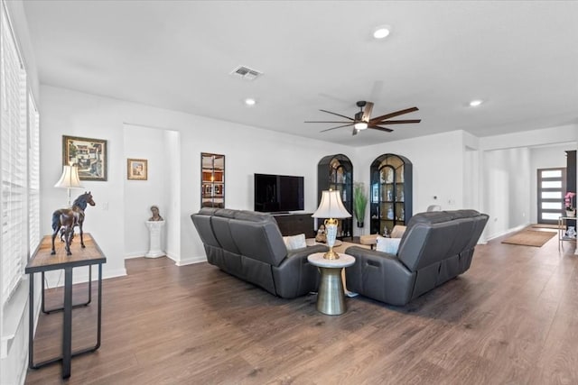 living room featuring ceiling fan and wood-type flooring