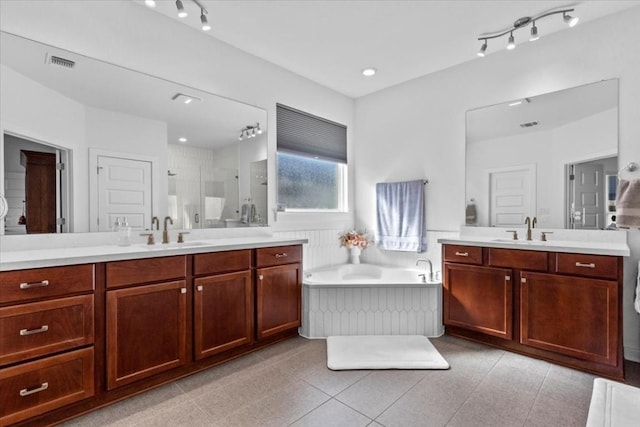 bathroom featuring plus walk in shower, tile patterned flooring, and vanity