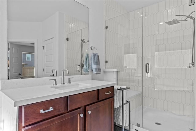 bathroom featuring vanity and an enclosed shower