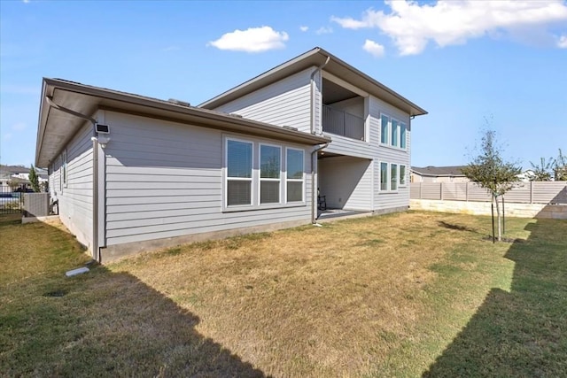 rear view of property featuring a lawn