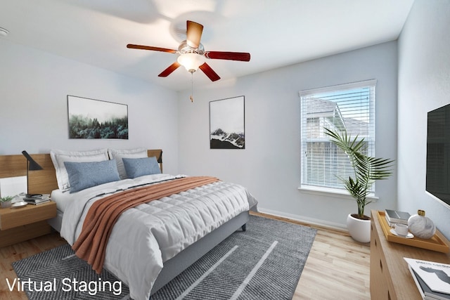 bedroom with ceiling fan and light wood-type flooring