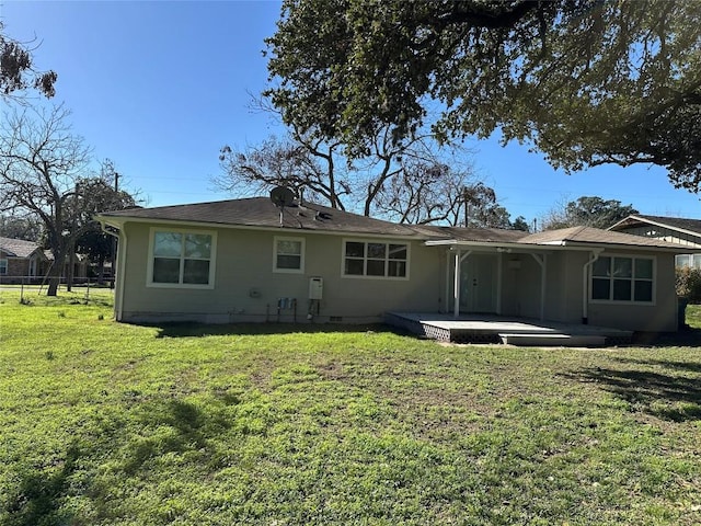 back of house with a lawn