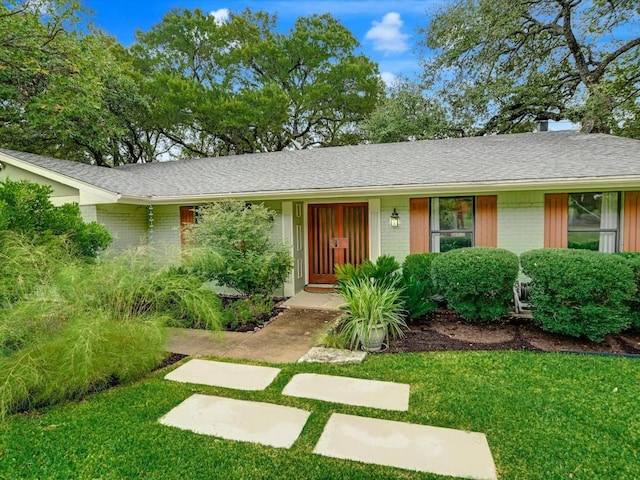 ranch-style house with a front yard