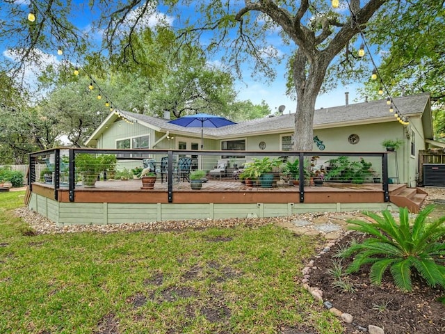 back of property featuring central AC unit, a lawn, and a wooden deck