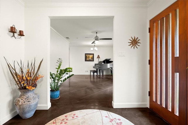 foyer with ceiling fan and ornamental molding