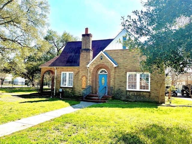 tudor-style house with a front yard