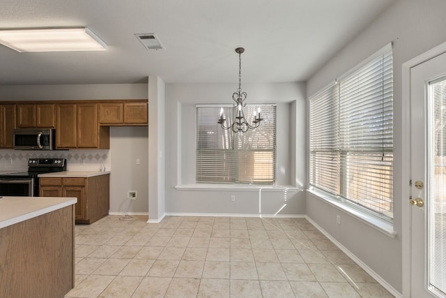 30004 Oakland Hills Dr, Georgetown, TX 78628 - kitchen with electric stove, stainless steel microwave, brown cabinetry, tasteful backsplash, and light tile patterned floors