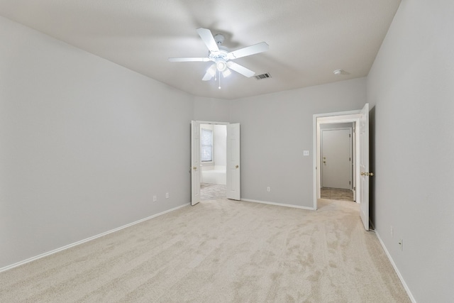 unfurnished bedroom with light carpet and ceiling fan