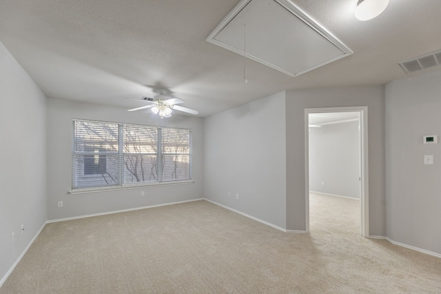 30004 Oakland Hills Dr, Georgetown, TX 78628 - spare room featuring attic access, light carpet, and ceiling fan