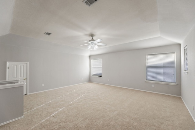 carpeted empty room with ceiling fan and lofted ceiling