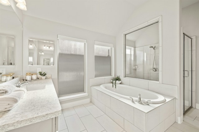 bathroom featuring tile patterned flooring, shower with separate bathtub, vanity, and lofted ceiling