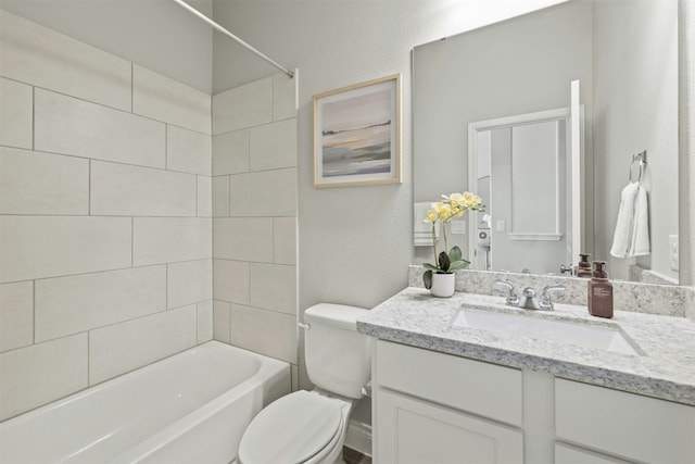 full bathroom with tiled shower / bath combo, toilet, and vanity