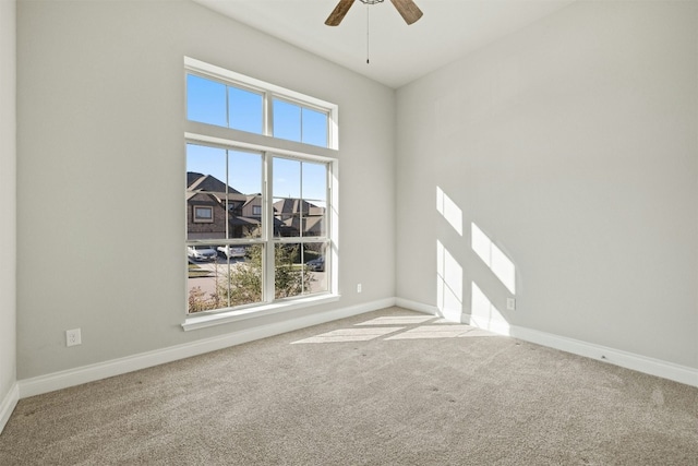 unfurnished room featuring ceiling fan and carpet floors