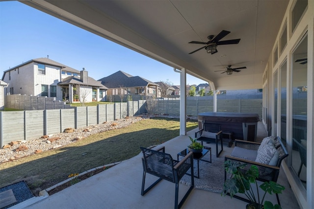 view of patio with outdoor lounge area, a hot tub, and ceiling fan