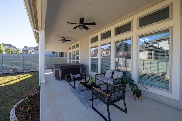 view of patio / terrace with outdoor lounge area, a hot tub, and ceiling fan