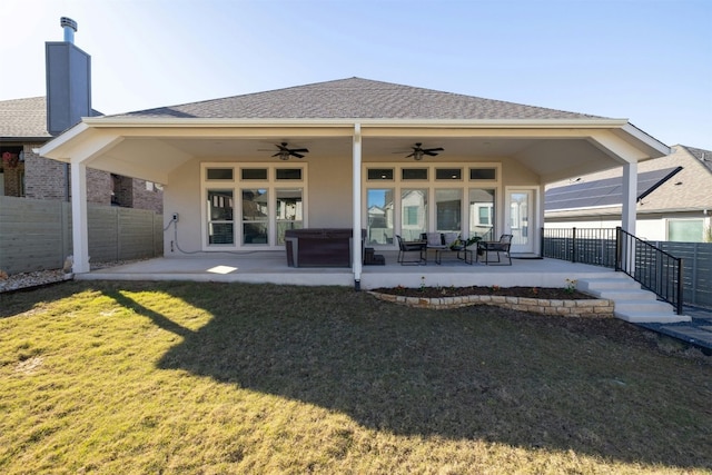 back of property featuring ceiling fan, a patio area, and a yard