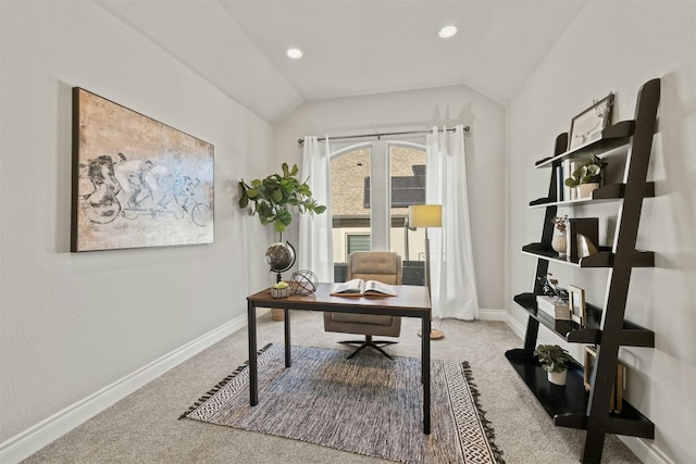 carpeted home office with vaulted ceiling