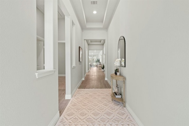 corridor with hardwood / wood-style flooring