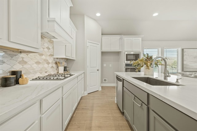 kitchen featuring white cabinets, sink, and light hardwood / wood-style flooring