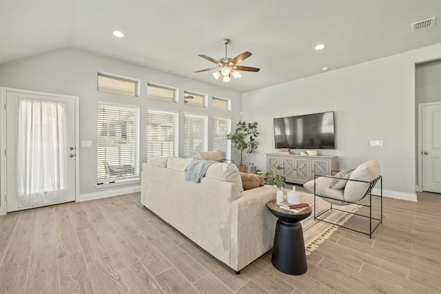 living room featuring ceiling fan and lofted ceiling