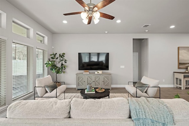 living room featuring ceiling fan and light wood-type flooring