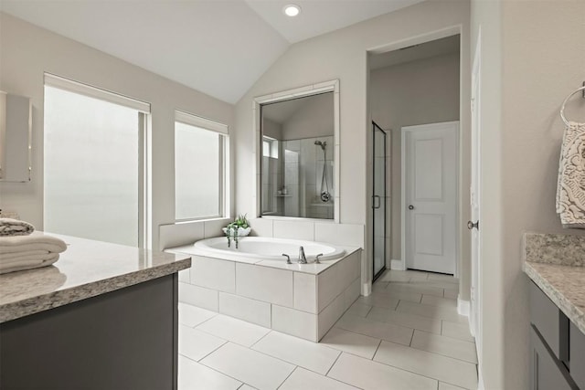 bathroom featuring lofted ceiling, vanity, independent shower and bath, and tile patterned floors