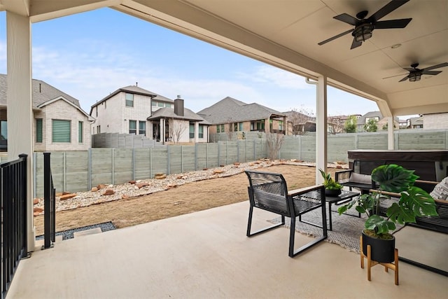 view of patio featuring ceiling fan and a hot tub