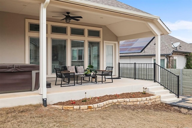 exterior space with a hot tub and ceiling fan