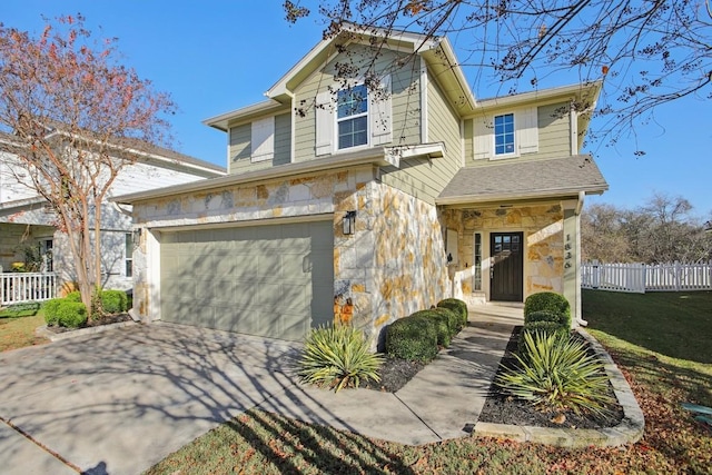 view of front of house with a garage and a front lawn