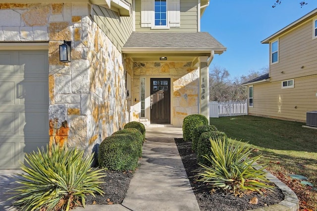 doorway to property with a yard and a garage