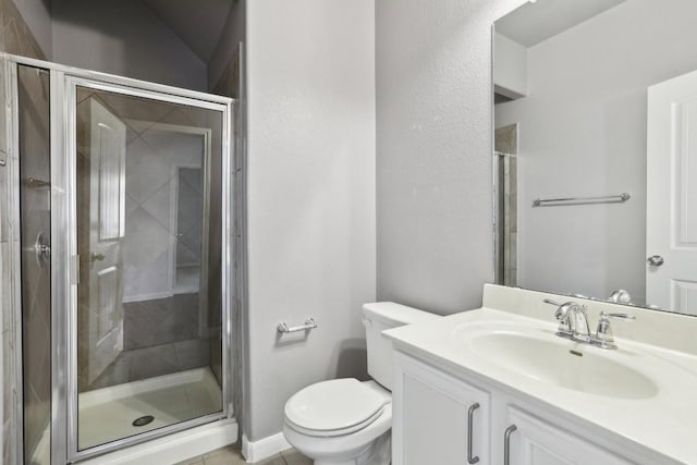 bathroom with tile patterned floors, vanity, an enclosed shower, and toilet